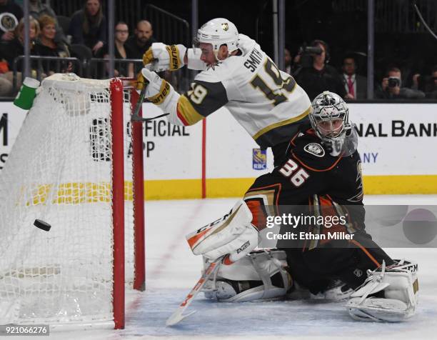 Reilly Smith of the Vegas Golden Knights knocks the goal loose as he trips over John Gibson of the Anaheim Ducks while trying to deflect the puck...