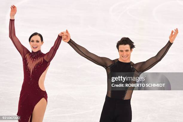 Canada's Tessa Virtue and Canada's Scott Moir celebrate during the venue ceremony after the ice dance free dance of the figure skating event during...