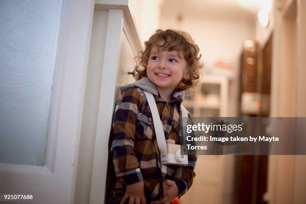 toddler looking playful with a toy camera on his neck - boy curly blonde stock pictures, royalty-free photos & images