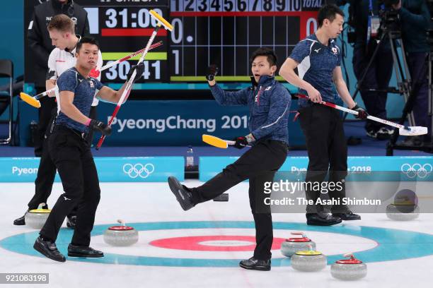 Tsuyoshi Yamaguchi, Kosuke Morozumi and Tetsuro Shimizu of Japan celebrate after scoring in the 2nd end during Curling Men's Round Robin session 10...