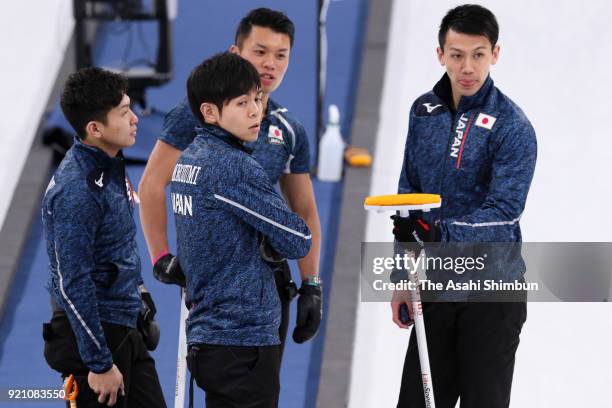 Kosuke Morozumi, Yusuke Morozumi, Tsuyoshi Yamaguchi and Tetsuro Shimizu of Japan discuss in the 1st end during Curling Men's Round Robin session 10...