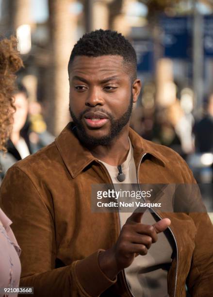 Winston Duke takes a selfie with fans at "Extra" at Universal Studios Hollywood on February 19, 2018 in Universal City, California.