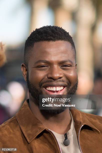 Winston Duke takes a selfie with fans at "Extra" at Universal Studios Hollywood on February 19, 2018 in Universal City, California.