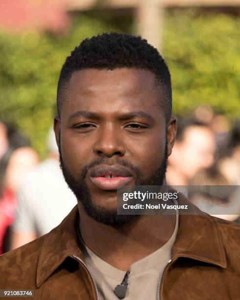 Winston Duke takes a selfie with fans at "Extra" at Universal Studios Hollywood on February 19, 2018 in Universal City, California.