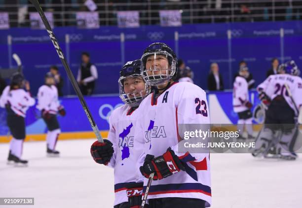 The Unified Korea team players react after the women's play-off classifications ice hockey match between the Unified Korea team and Sweden during the...