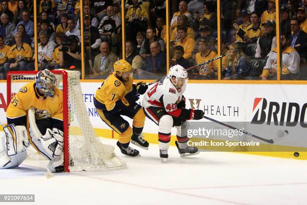 Nashville Predators goalie Pekka Rinne protects the post as Nashville Predators defenseman Yannick Weber defends against Ottawa Senators right wing...