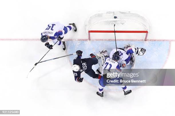 Troy Terry of the United States falls to to the ice after a play in the crease against Jan Laco of Slovakia during the Men's Play-offs Qualifications...