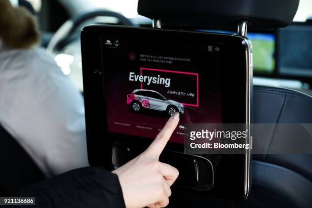 Visitor uses a touch screen inside a Hyundai Motor Co. Nexo autonomous fuel cell electric vehicle during a test drive in Pyeongchang, Gangwon...