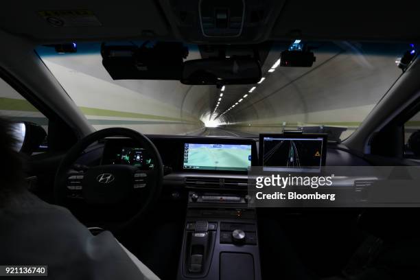 An engineer rides in the driver's seat of a Hyundai Motor Co. Nexo autonomous fuel cell electric vehicle during a test drive in Pyeongchang, Gangwon...