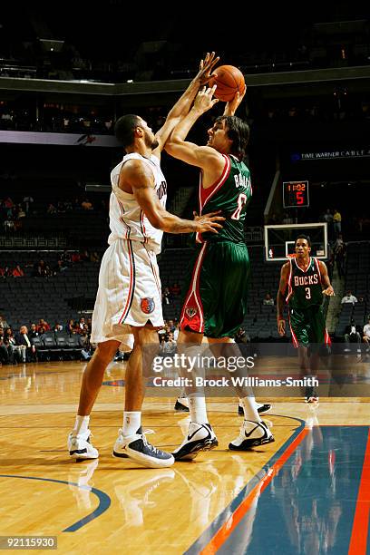 Nazr Mohammed of the Charlotte Bobcats guards against Andrew Bogut of the Milwaukee Bucks on October 20, 2009 at Time Warner Cable Arena in...