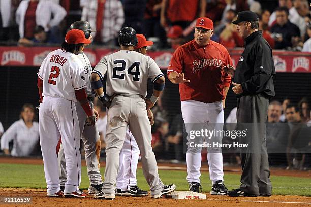 Manager Mike Scioscia of the Los Angeles Angels of Anaheim questions a call with the third base umpire Tim McClelland after Mike Napol forced Jorge...