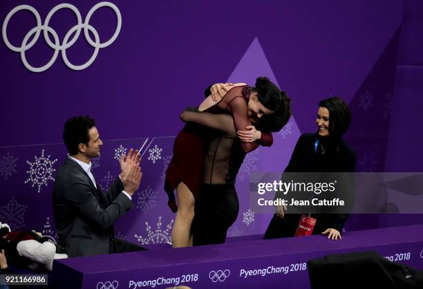 Tessa Virtue and Scott Moir of Canada celebrate winning the gold medal along their coaches Marie-France Dubreuil and Patrice Lauzon at 'kiss and cry...