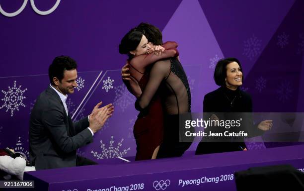 Tessa Virtue and Scott Moir of Canada celebrate winning the gold medal along their coaches Marie-France Dubreuil and Patrice Lauzon at 'kiss and cry...
