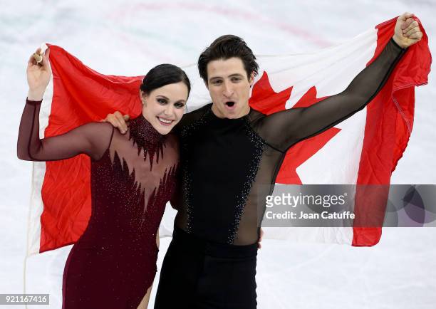 Tessa Virtue and Scott Moir of Canada celebrate the gold medal during the venue victory ceremony following the Figure Skating Ice Dance Free Dance...