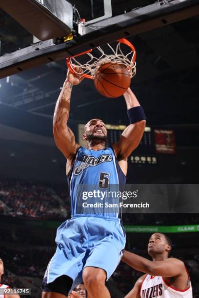 Carlos Boozer of the Utah Jazz dunks the ball over Jarron Collins of the Portland Trail Blazers in a preseason game on October 20, 2009 at the Rose...