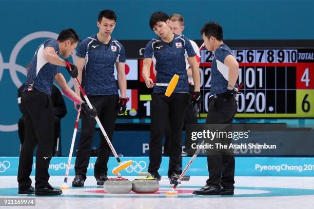 Tsuyoshi Yamaguchi, Tetsuro Shimizu, Yusuke Morozumi and Kosuke Morozumi of Japan discuss in the 8th end during Curling Men's Round Robin session 10...