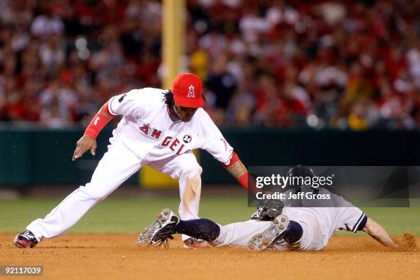 Erick Aybar of the Los Angeles Angels of Anaheim tags out Brett Gardner of the New York Yankees attempting to steal second base during the eighth...
