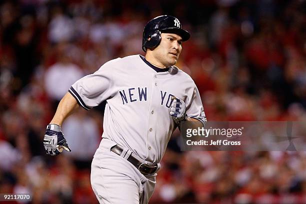 Johnny Damon of the New York Yankees rounds the bases after hitting a two run home run during the eighth inning in Game Four of the ALCS against the...