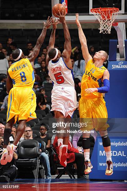 Craig Smith of the Los Angeles Clippers attempts a shot between Doron Perkins and Maciej Lampe of Maccabi Electra Tel Aviv at Staples Center on...