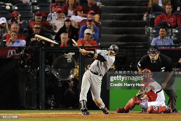 Jorge Posada of the New York Yankees flies out to right field scoring teammate Alex Rodriguez on Bobby Abreu of the Los Angeles Angels of Anaheim...