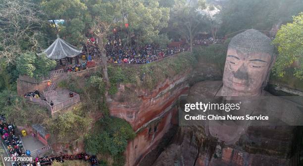 Tourists visit the Leshan Giant Buddha on February 20, 2018 in Leshan, Sichuan Province of China. Thousands of tourists waited about four hours to...