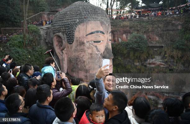 Man takes selfie with the Leshan Giant Buddha on February 20, 2018 in Leshan, Sichuan Province of China. Thousands of tourists waited about four...