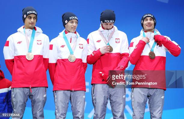 Bronze medalists Maciej Kot, Stefan Hula, Dawid Kubacki and Kamil Stoch of Poland celebrate during the medal ceremony for Ski Jumping - Men's Team on...