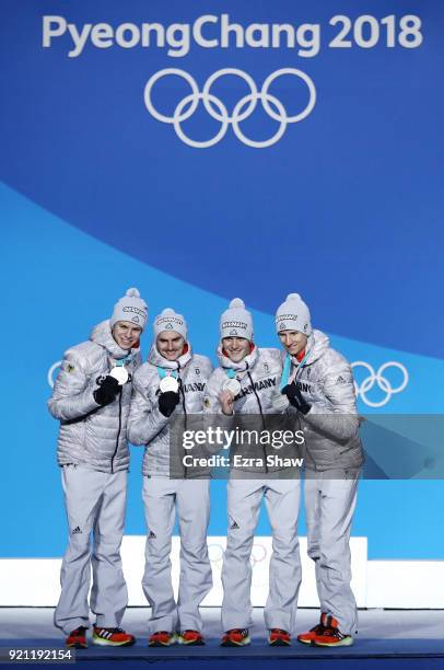 Silver medalists Karl Geiger, Stephan Leyhe, Richard Freitag and Andreas Wellinger of Germany celebrate during the medal ceremony for Ski Jumping -...