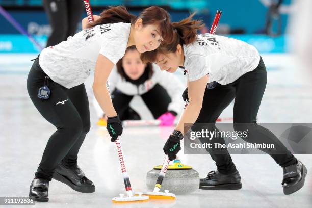 Yurika Yoshida and Yumi Suzuki of Japan sweep in the 3rd end during the Curling Women's Round Robin session 10 against Great Britain on day eleven of...