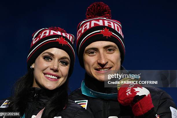 Canada's gold medallists Tessa Virtue and Scott Moir pose on the podium during the medal ceremony for the figure skating ice dance at the Pyeongchang...
