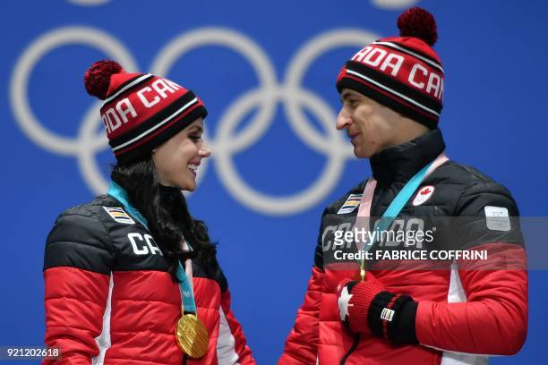 Canada's gold medallists Tessa Virtue and Scott Moir pose on the podium during the medal ceremony for the figure skating ice dance at the Pyeongchang...