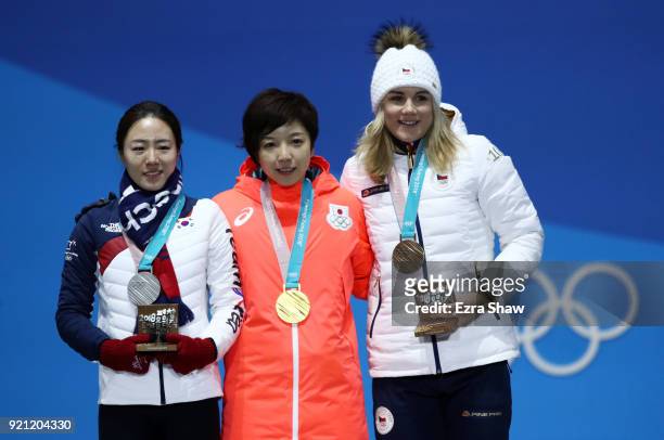 Silver medalist Sang-Hwa Lee of Korea, gold medalist Nao Kodaira of Japan and bronze medalist Karolina Erbanova of the Czech Republic celebrate...