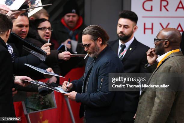 Joaquin Phoenix signs autographs for fans before attending the 'Don't Worry, He Won't Get Far on Foot' photo call during the 68th Berlinale...