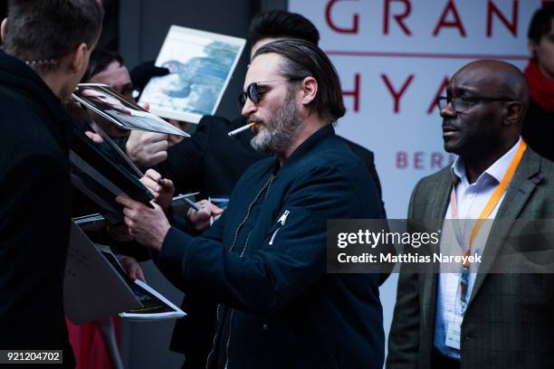 Joaquin Phoenix signs autographs for fans before attending the 'Don't Worry, He Won't Get Far on Foot' photo call during the 68th Berlinale...