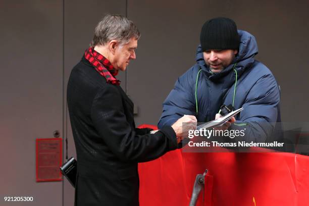 Gus Van Sant signs an autograph for a fan before attending the 'Don't Worry, He Won't Get Far on Foot' photo call during the 68th Berlinale...