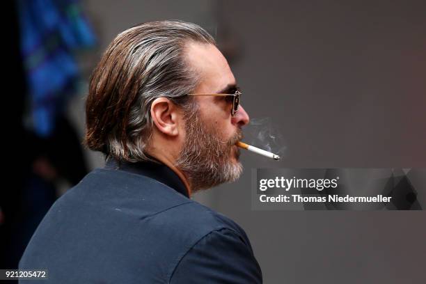 Joaquin Phoenix smokes a cigarette at the 'Don't Worry, He Won't Get Far on Foot' photo call during the 68th Berlinale International Film Festival...