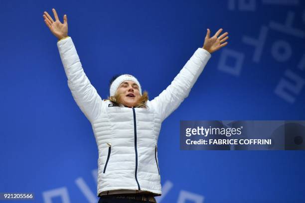 Czech Republic's bronze medallist Karolina Erbanovab celebrates on the podium during the medal ceremony for the speed skating women's 500m at the...