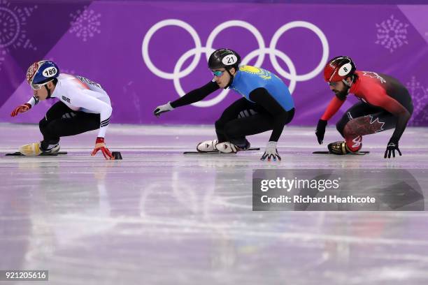 Hyojun Lim of Korea, Denis Nikisha of Kazakhstan and Charles Hamelin of Canada compete during the Men's Short Track Speed Skating 500m Heats on day...