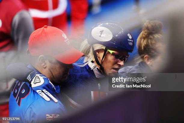 Elise Christie of Great Britain is helped from the Ice Rink after competing in the heats of the Women's 1000m at Gangneung Ice Arena on February 20,...