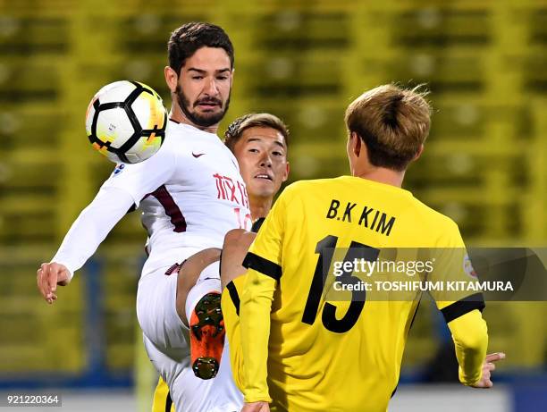 Tianjin Quanjian forward Alexandre Pato controls the ball next to Kashiwa Reysol defender Ryuta Koike and midfielder Kim Bo-Kyung during their AFC...