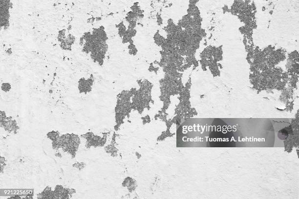 weathered and deteriorated concrete wall texture background in black and white. - chipping stock pictures, royalty-free photos & images