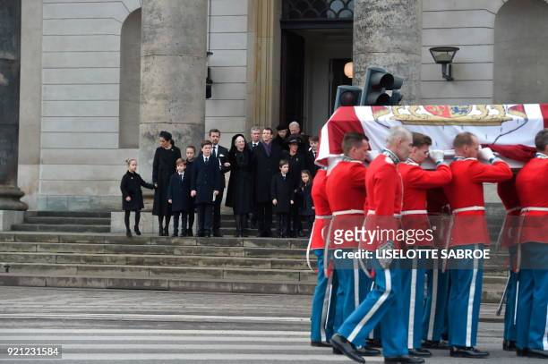 The royal Danish family looks on as soldiers carry the bier of Prince Henrik after the funeral at Christiansborg Palace Chapel in Copenhagen on...