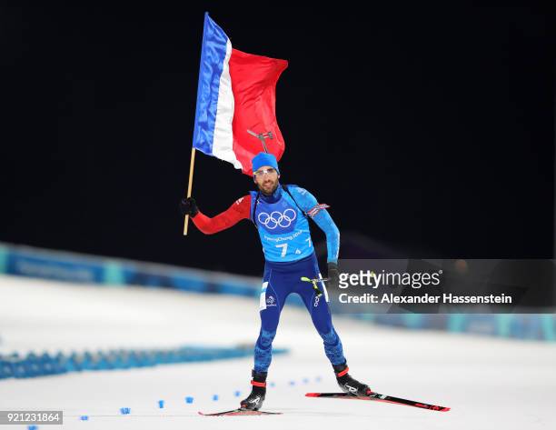 Martin Fourcade of France celebrates winning the gold medal during the Biathlon 2x6km Women + 2x7.5km Men Mixed Relay on day 11 of the PyeongChang...