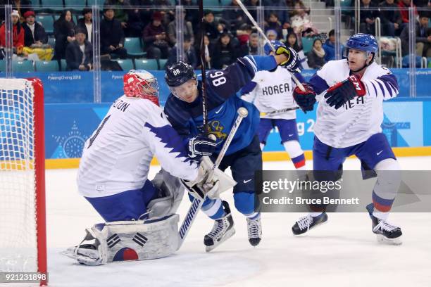 Veli-Matti Savinainen of Finland makes a shot on Matt Dalton of Korea during the Men's Play-offs Qualifications game on day eleven of the PyeongChang...