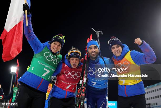 Anais Bescond, Marie Dorin Habert, Martin Fourcade and Simon Desthieux of France celebrate after winning the gold medal during the Biathlon 2x6km...