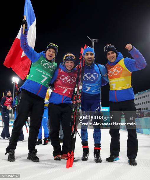 Anais Bescond, Marie Dorin Habert, Martin Fourcade and Simon Desthieux of France celebrate after winning the gold medal during the Biathlon 2x6km...