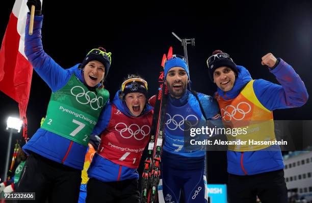 Anais Bescond, Marie Dorin Habert, Martin Fourcade and Simon Desthieux of France celebrate after winning the gold medal during the Biathlon 2x6km...