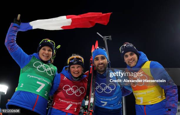 Anais Bescond, Marie Dorin Habert, Martin Fourcade and Simon Desthieux of France celebrate after winning the gold medal during the Biathlon 2x6km...