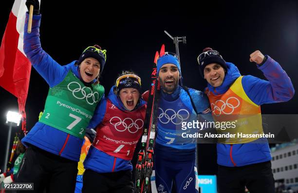 Anais Bescond, Marie Dorin Habert, Martin Fourcade and Simon Desthieux of France celebrate after winning the gold medal during the Biathlon 2x6km...