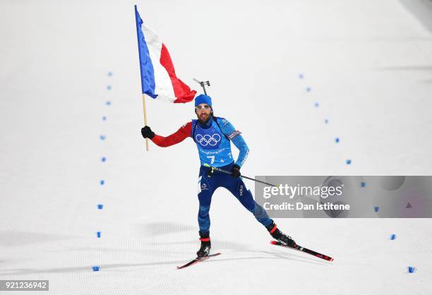 Martin Fourcade of France celebrates winning the gold medal during the Biathlon 2x6km Women + 2x7.5km Men Mixed Relay on day 11 of the PyeongChang...